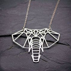 Inspired by the ancient art of paper folding, this cutout elephant pendant resembles an origami animal!   Metal Type: Zinc Alloy Chain Type: Link Chain - 20" (approx) with Extender of approx. 1.75" Pendant Size: 2"  X 1.75" (approx)    #elephant    #ElephantNecklace    #ElephantJewelry Everyday Accessories Jewelry, Elephant Necklace Gold, Geometric Elephant, Origami Elephant, Origami Necklace, Jewelry Design Studio, Origami Jewelry, Silver Elephant, Lucky Elephant