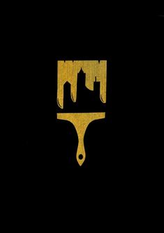 a black and gold logo with a city in the background on a yellow paintbrush