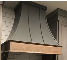 a kitchen stove with a large hood over it's burner and counter top