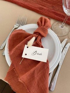 a place setting with napkins and silverware