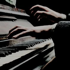 two hands are playing the piano together