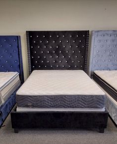 three different types of mattresses in a room with carpeted flooring and walls