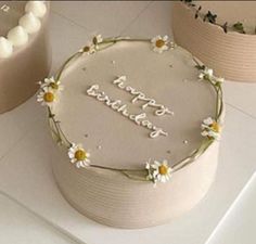 a birthday cake decorated with daisies and the words happy birthday written in frosting