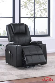 a black recliner chair sitting in front of a window