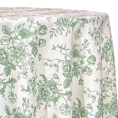 a green and white table cloth with flowers on it, in front of a white background