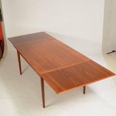 a wooden table sitting on top of a white floor