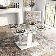 a glass table with plates and silverware on it in front of a white fireplace