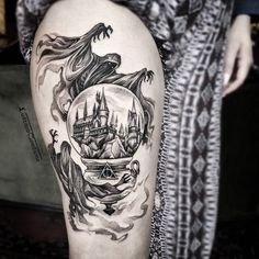 a woman's thigh with an image of a castle in the middle of it