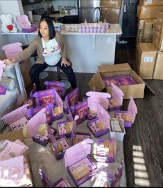 a woman sitting on a chair surrounded by boxes