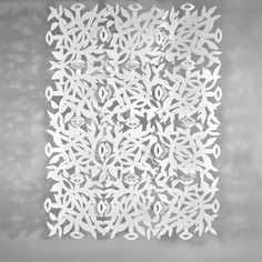 a white paper cut out into the shape of a snowflake on a gray background