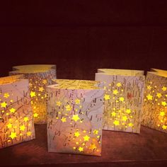 four small bags with yellow stars on them sitting on a wooden table next to each other