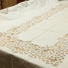 the table cloth is white and has lacy doily on it