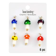 six different colors of mushroom charms on a card with the words bead landing charms