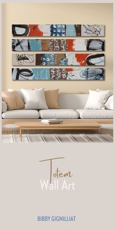 a living room with white couches and paintings on the wall above it that says totem wall art