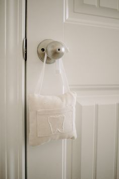 a tooth shaped bag hanging on a door handle