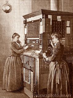 two women are working on an old fashioned machine