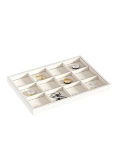 an open drawer with scissors and other items in it on a white surface, isolated against a white background