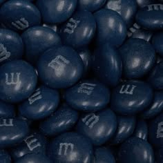 blue chocolate candies with letters and numbers on them are shown in close up view