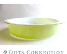 a green bowl sitting on top of a white counter next to the words dots connection