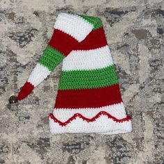 a crocheted christmas dress laying on the ground