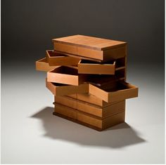 a stack of wooden drawers sitting on top of a white floor next to each other