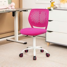 a pink office chair sits in front of a desk with drawers and toys on it