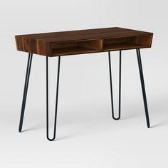 a wooden desk with hairpin legs and a drawer on the top, against a white background