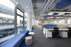 an empty office with blue and white furniture