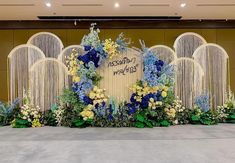 a floral display with blue and yellow flowers in front of a sign that says kissamoo wedding