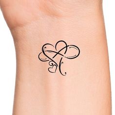 a woman's wrist with a small tattoo on the side of her left arm