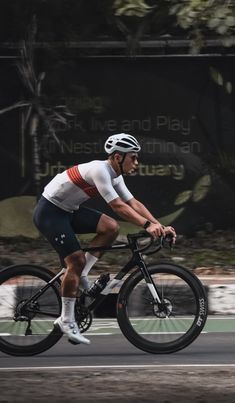 a man riding a bike down a street