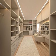 a large walk in closet with lots of shelves and drawers on the wall, along with a white chair