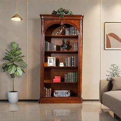 a living room filled with furniture and a tall wooden book shelf next to a couch