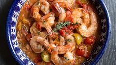 a bowl filled with shrimp and vegetables on top of a table