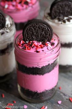 oreo cookies and sprinkles are on top of the dessert in jars