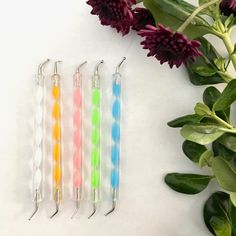 four different colored toothbrushes sitting next to each other on top of a table