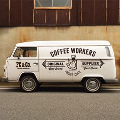 an old white van is parked in front of a building with the words coffee workers on it