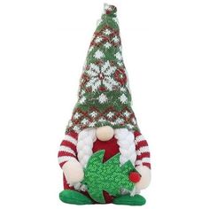 a stuffed toy with a christmas tree on it's head and legs, sitting in front of a white background