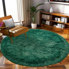 a living room with a green rug on the floor and a chair next to it