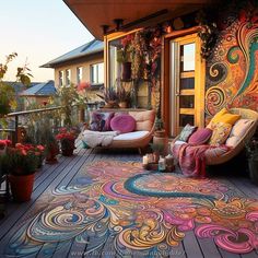 an outdoor area with colorful rugs and chairs on the deck, surrounded by potted plants