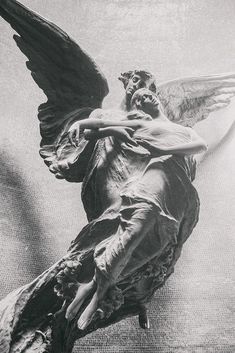 an angel statue is shown in black and white