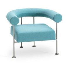 a blue chair sitting on top of a white floor next to a metal frame and foot rest