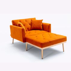 an orange chair and ottoman with pillows on the armrests, sitting in front of a white background