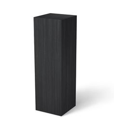 a tall black wooden object on a white background