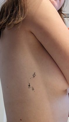 a woman's breast with small stars on it