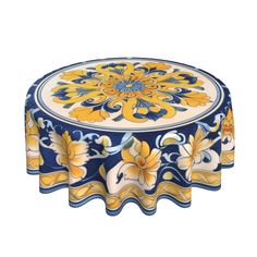 a blue and yellow table cloth with flowers on the top, sitting in front of a white background