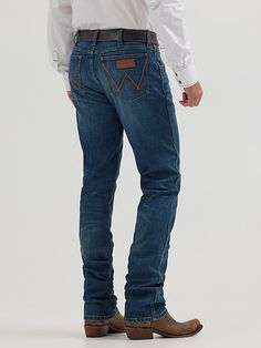 OUR WESTERN ROOTS MADE MODERN Wrangler® Retro® slim fit jeans nod to our history while introducing fits and washes suited for the modern cowboy. Designed with a closer fit and leg opening that still falls comfortably over boots, our men's Wrangler® straight leg slim fit jeans add extra style to the classic look you love. These jeans sit low on the waist and make it easy to show off your favorite belt buckle. That design detail is our Western heritage showing through, something that happens often Men’s Wrangler Jeans, Vintage Wrangler Jeans Outfit, Mens Western Jeans, Cowboy Pants, Modern Cowboy, Vintage Wrangler Jeans, Straight Leg Jeans Men, Western Jeans, Mens Cowboy