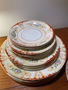 a stack of plates sitting on top of a wooden table