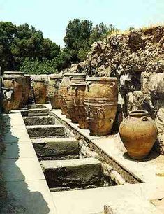 several large vases sitting on top of cement steps