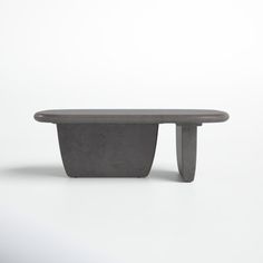 a concrete bench sitting on top of a white floor